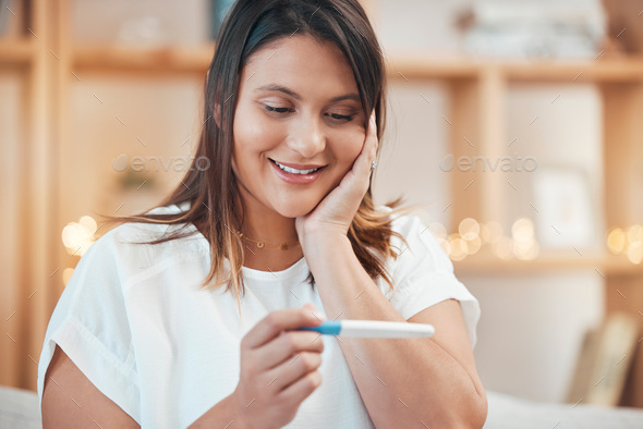 Wow, pregnancy test results and indian woman on sofa of living room at home with a happy surprise,