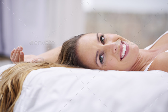 Theres nothing like a laid-back weekend. Portrait of a beautiful woman lying on her bed.