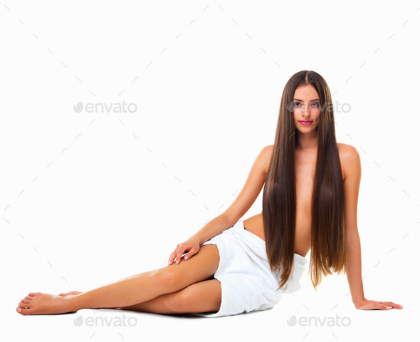 Studio portrait of a young woman with long silky hair against a white background