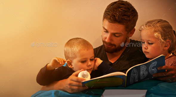 And then they lived happily ever after...A father reading a bedtime story to his kids.