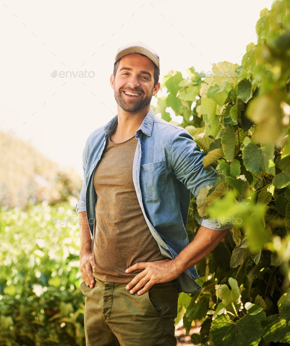 Farming is my life. Portrait of a cheerful young farmer posing in the ...