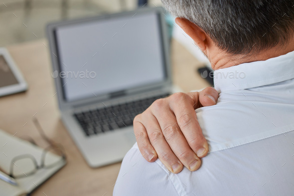 Shoulder pain, businessman at laptop in office with stress, anxiety and heart attack risk. Ceo, fat