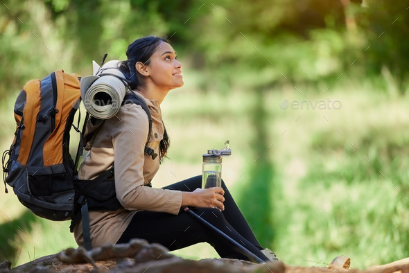 Black woman, hiking and rest sitting in nature, woods or forest for goal, motivation or outdoor adv