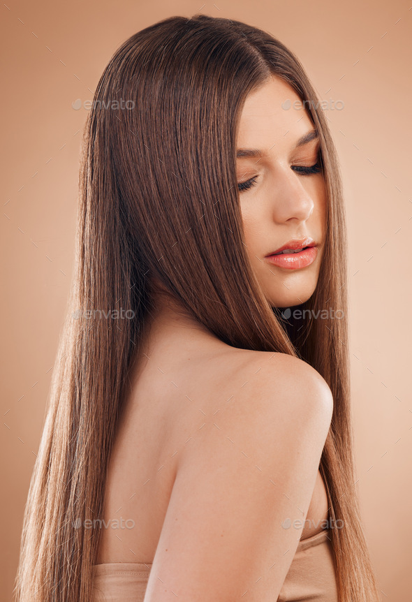 Woman, beauty and hair care in studio for shine, glow and long straight  texture on brown background Stock Photo by YuriArcursPeopleimages