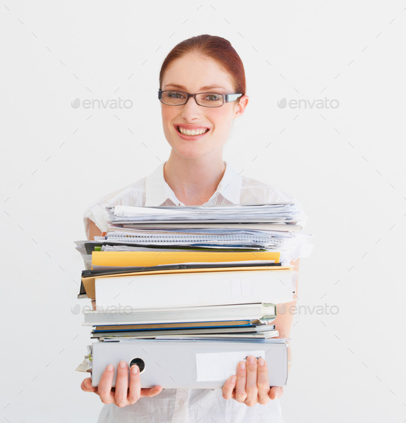 Time to hit the books. A student carrying a pile of files and books.
