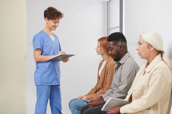 Medical Worker Checking Patient Attendance