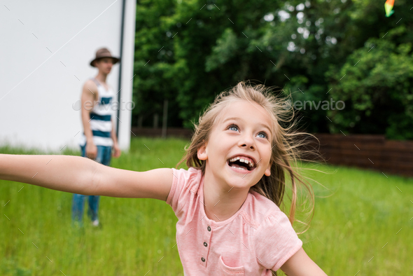 selective focus of happy kid smiling near father outside Stock Photo by ...