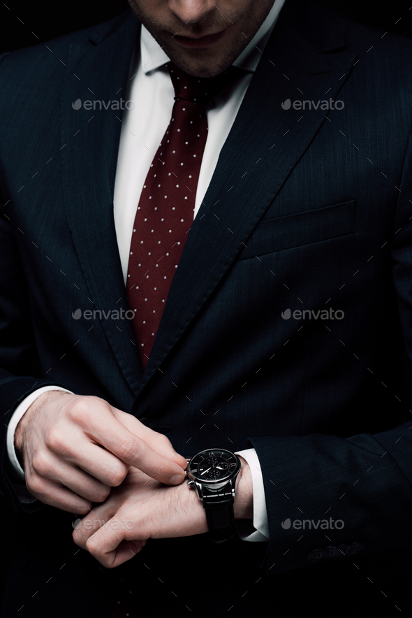 Picture of black man looking at watch Stock Photos - Page 1 : Masterfile