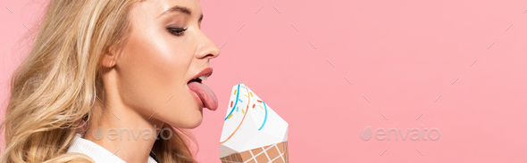 side view of beautiful sexy blonde woman in white faux fur jacket licking decorative ice cream