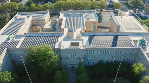 Aerial Drone Shot Flying Over a Large PV Solar Installation on Bayside HS Roof