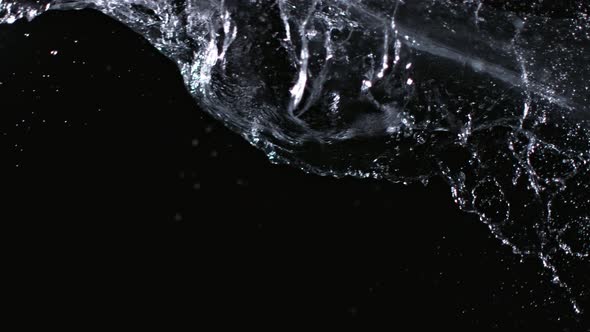 Super Slowmotion Shot of Water Splash Against Black at 1000Fps alt