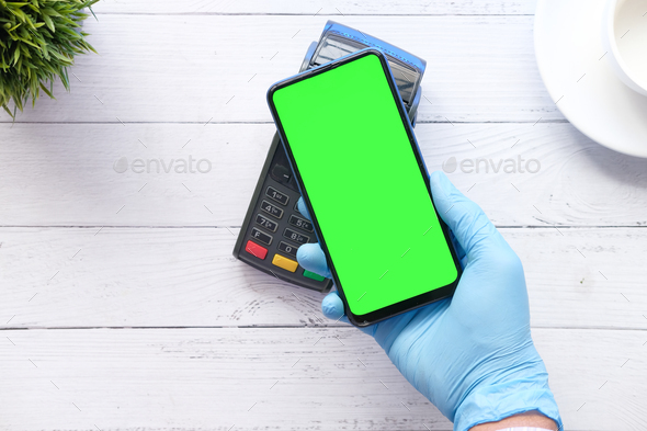 hand in latex gloves contactless payment with smart phone