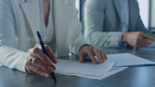 Closeup hands checking papers on corporate meeting. Business partners exchanging