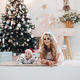 Joyful mother and her cute baby posing for Christmas photo - PhotoDune Item for Sale