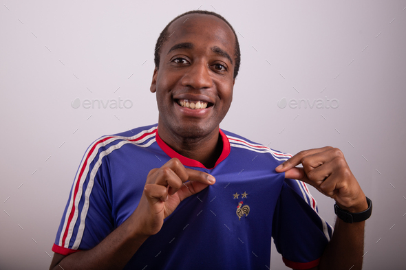 French fan is happy and celebrates the victory of France wearing the french jersey