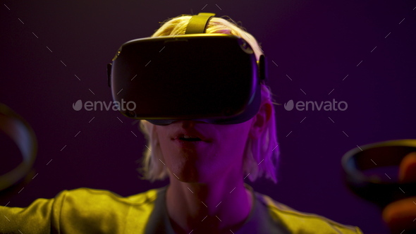 Surprised gamer playing videogame neon light. Man travelling invisible vr world