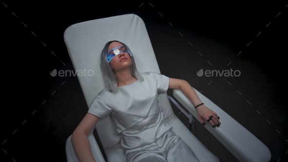 Teenager sitting interactive motion simulator. Girl enjoying artificial reality