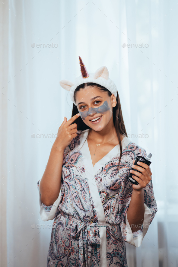 Woman applying facial mask on her face. Skin care concept - Stock Photo - Images