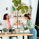 Two young women is taking care of houseplants watering and spraying with water. - PhotoDune Item for Sale