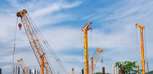 Construction crane Huge crane against blue sky Self-erection crane Tower crane - Stock Photo - Images