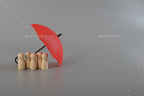 Red umbrella and the group of workers. Medical insurance, labor safety and health protection