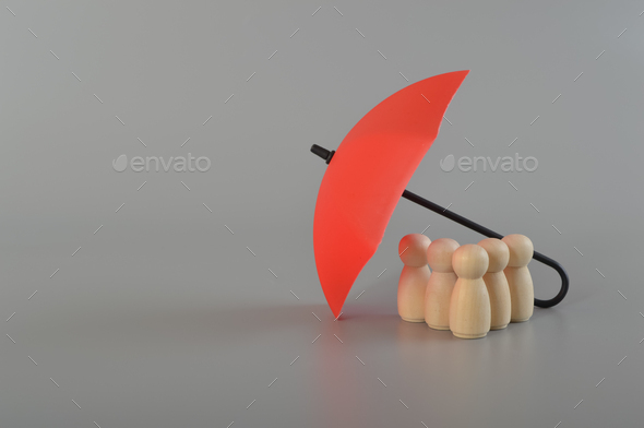 Red umbrella and the group of workers.Medical insurance,labor safety and health protection insurance