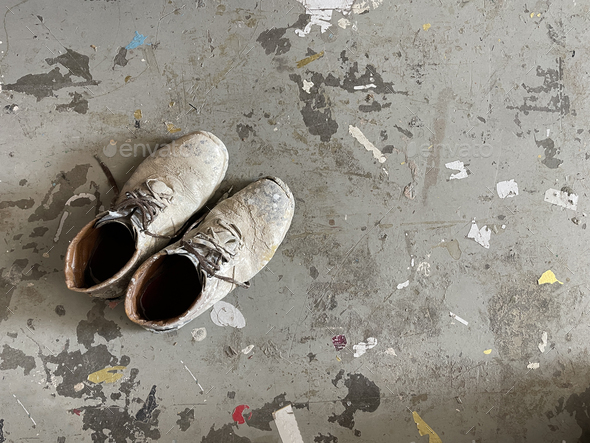 Shoes covered in paint on the grey background - Stock Photo - Images