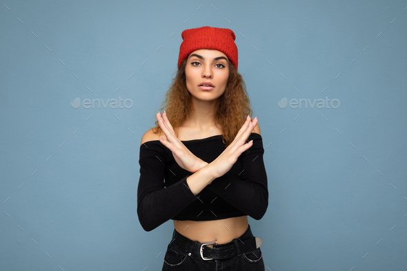 Shot of young nice winsome brunet woman wavy-haired with sincere emotions wearing black crop top and
