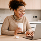 Young beautiful happy smiling african woman with coffee and laptop - PhotoDune Item for Sale