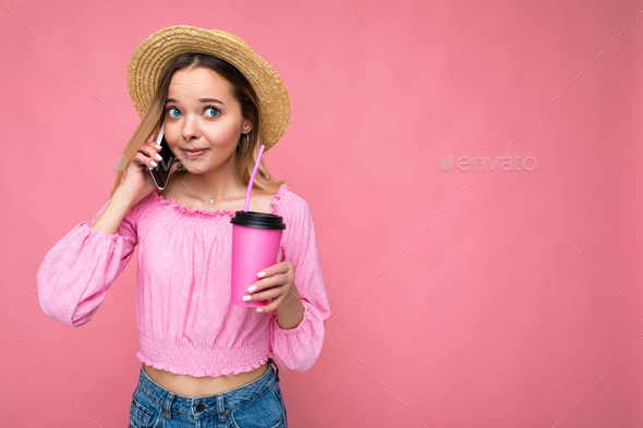 Photo of beautiful positive emotional young blonde woman wearing pink crop blouse and straw hat