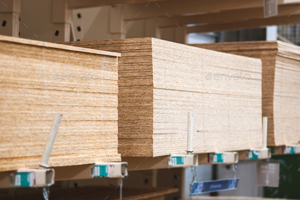 OSB boards in stock, chipboard stacked on pallets in building materials and supplies store - Stock Photo - Images