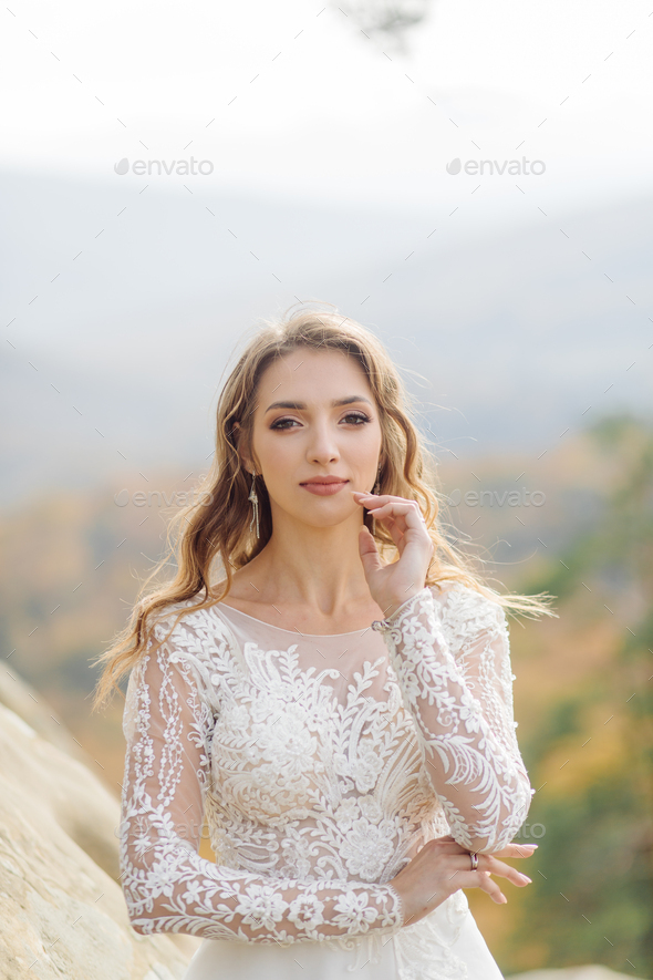 Beautiful bride in white dress posing. - Stock Photo - Images