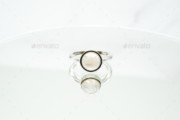Circular ring made of rainbow moonstone on a white surface