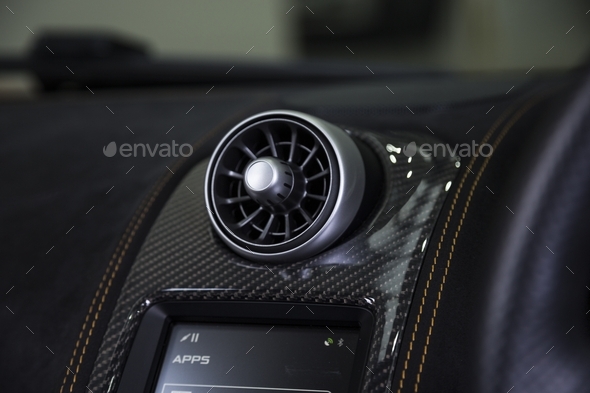Closeup shot of car aircon on a black dashboard in a car - Stock Photo - Images
