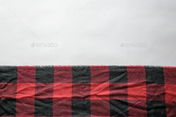 High angle shot of a black and red flannel cloth on a white surface