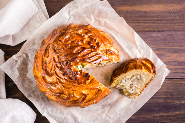 A piece of kurnik pie with chicken, potatoes and rice on a plate. Homemade  pastries Stock Photo by Aleruana