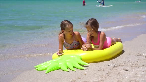 Little Girls Having Fun at Tropical Beach During Summer Vacation Playing Together
