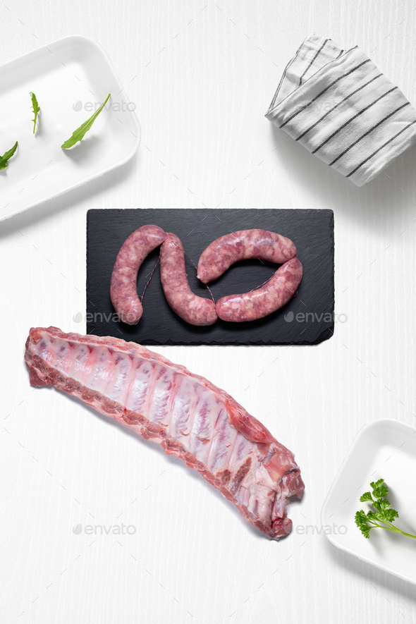 Criollo chorizo and pork ribs on a kitchen with some herbs - Stock Photo - Images