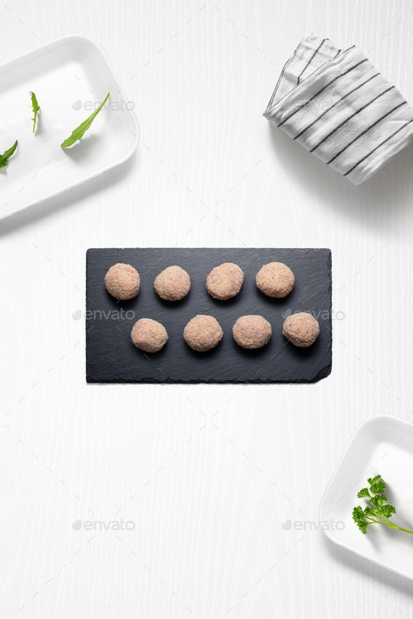 Meatballs on a kitchen with some herbs - Stock Photo - Images