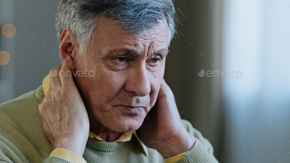 Sad old caucasian man suffer from neck pain 60s upset male tired grandfather feel ache in spine hurt