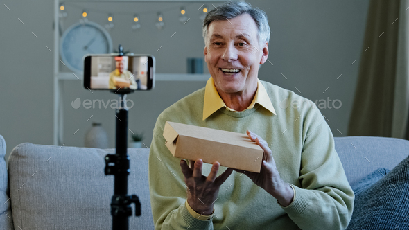 Elderly vlogger record videoblog online stream on social networks old man conducts live broadcast