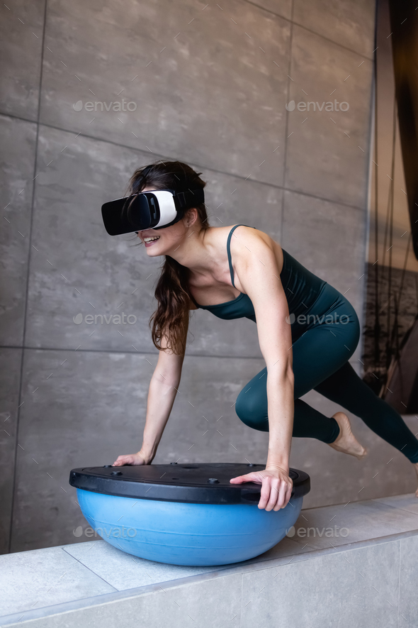 Beautiful girl doing fitness in the digital universe. Fitness of the future.