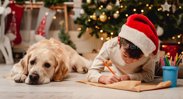 Little boy writing letter to santa