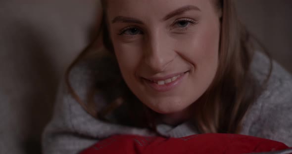 Woman Browsing Internet on Mobile Phone and Smile Into Camera alt