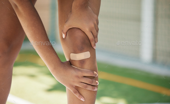 Woman athlete, knee pain and sport injury outdoor with bandaid with. inflammation, joint and bad ac