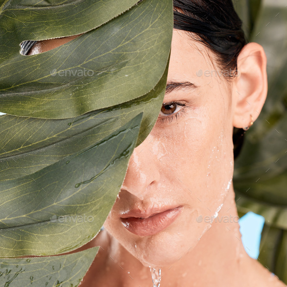 Woman, skincare and jungle leaves by face with water drop, moisturizer and wellness with mystery. P