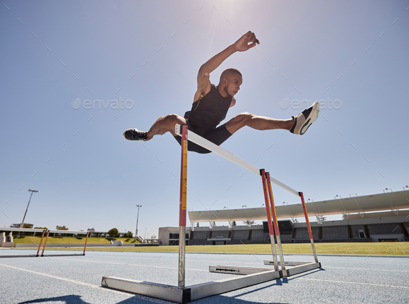 Running, jump and athlete hurdle for a speed exercise, marathon or runner training in a stadium. Sh
