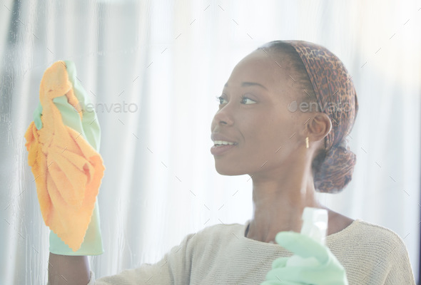 Cleaning, window and black woman with spray and cloth for dust, bacteria and housekeeping service.