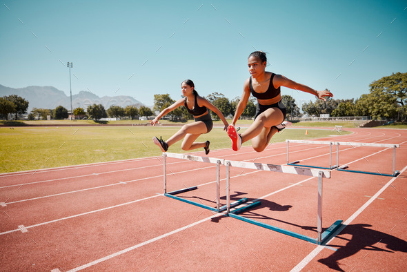 Sport, jump and women runner doing hurdles on stadium track, athlete running race and fitness train