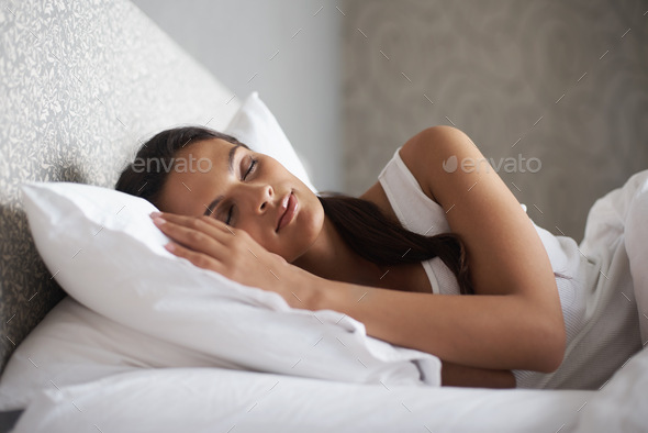 Sweet dreams in process. A beautiful young woman sleeping in her bed. - Stock Photo - Images